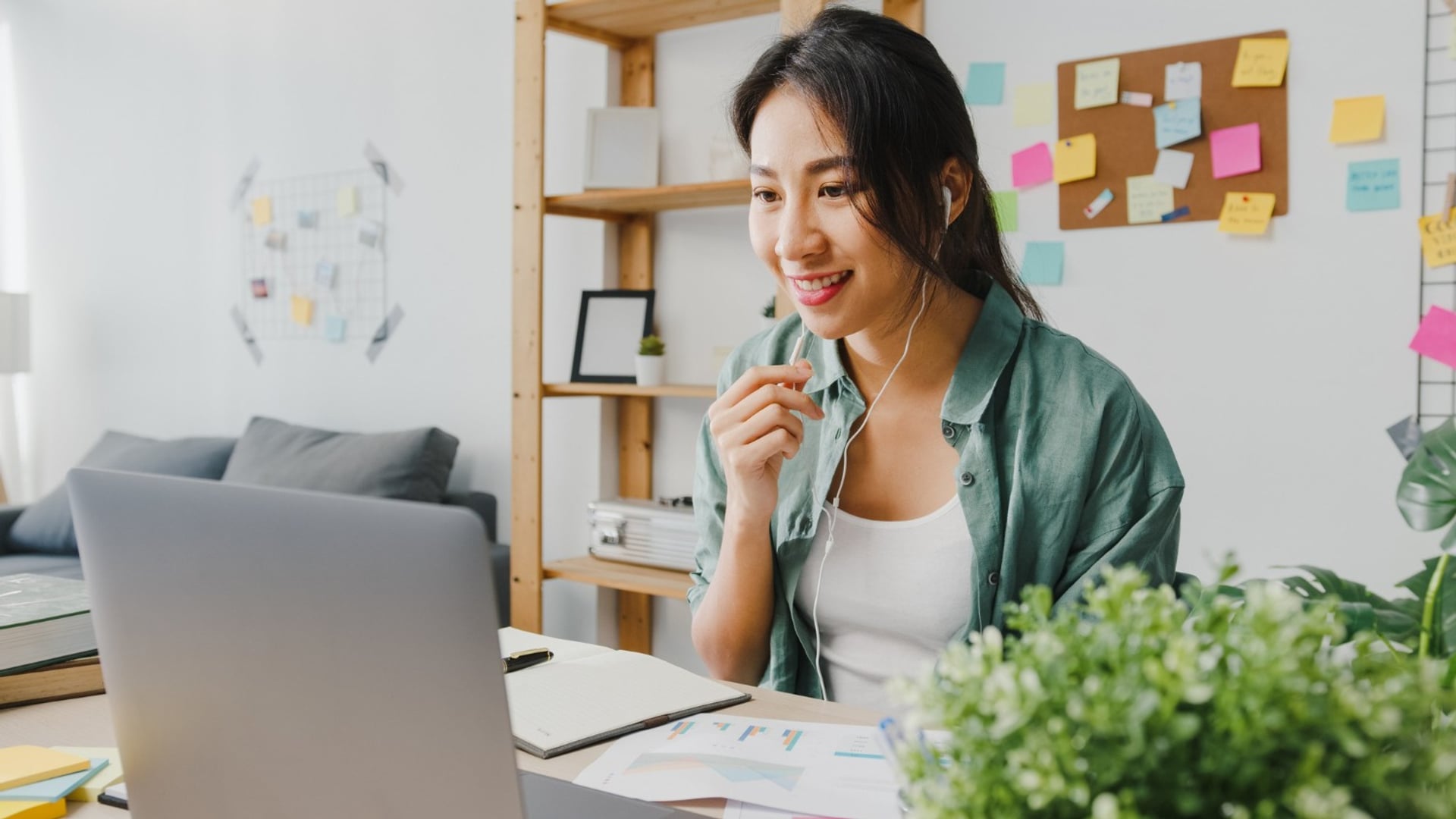 A social media assistant smiling at her phone while drafting a post