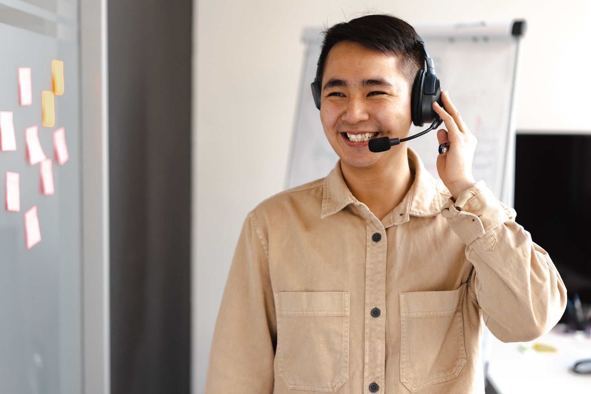 A real estate virtual assistant smiling on a headset call with a client