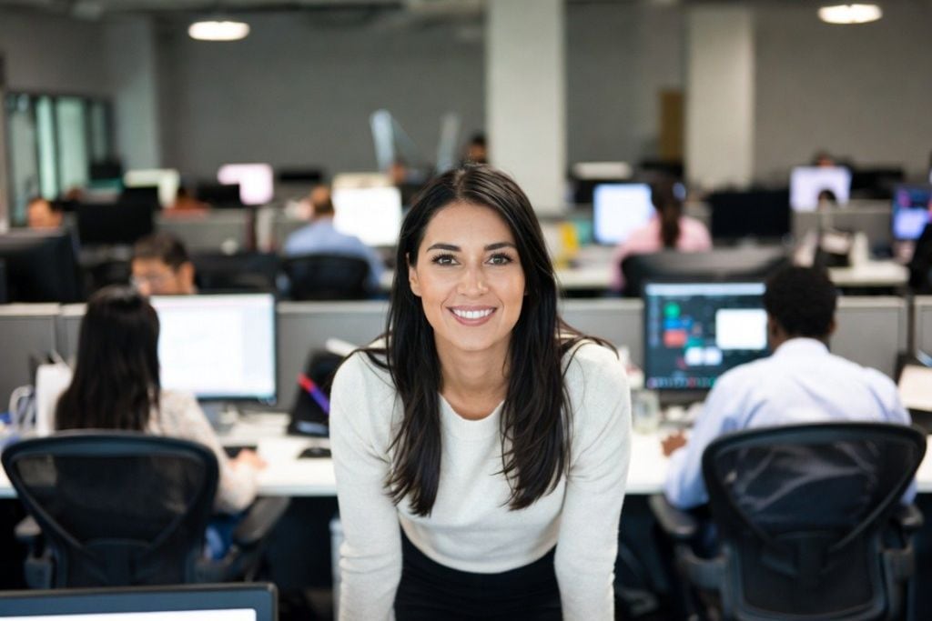 A personal assistant on the phone while organizing a calendar at a tidy desk